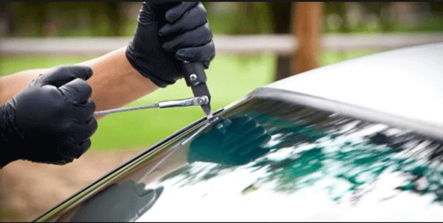 Technician performing windshield repair